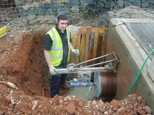 A 500mm hole cored through a reinforced sewage tank. - Drilling Companies Belfast
