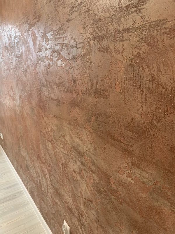 Textured Venetian plaster feature wall in bronze tones.