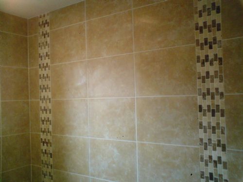 Porcelain bathroom tiles with 2 vertical mosaic borders.