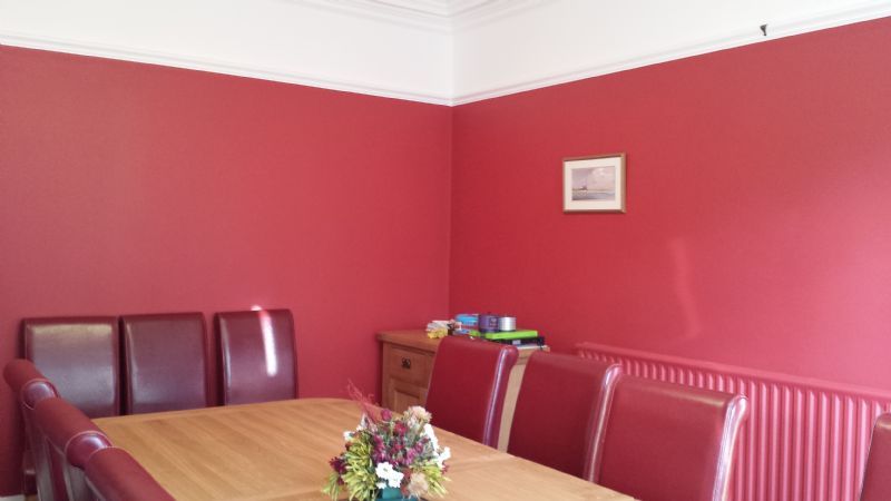 Dining room with matching colour coded radiator to blend into the wall