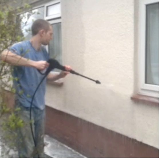 Exterior wall cleaning of painted finish, using antifungicide. This is part of a restoration involving patch repair of pebble dash and re coating.