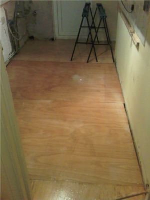 Level out joists and replace floor boards with plywood