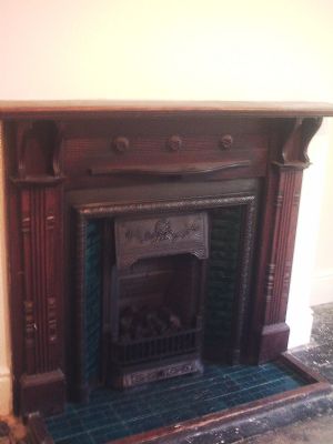 Unrestored oak fire surround.