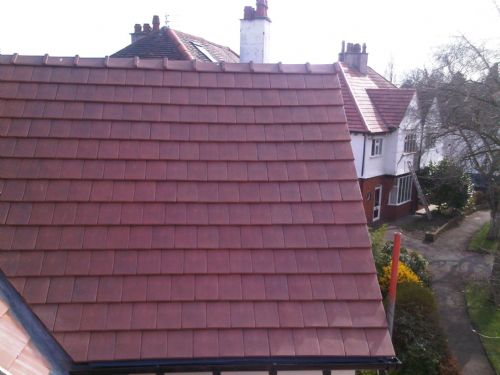 Clay flanders 20/20 tile with angle capped ridge in Chorlton by HQ Roofers in Manchester