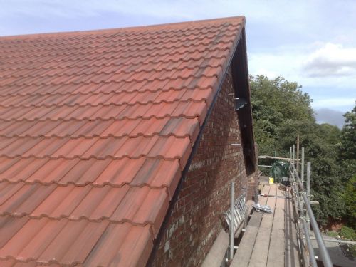 New Sandtoft Rustic Double Roman roof tiles with cloaked verge tiles and segmental ridges in Stretford by HQ Roofers in Manchester